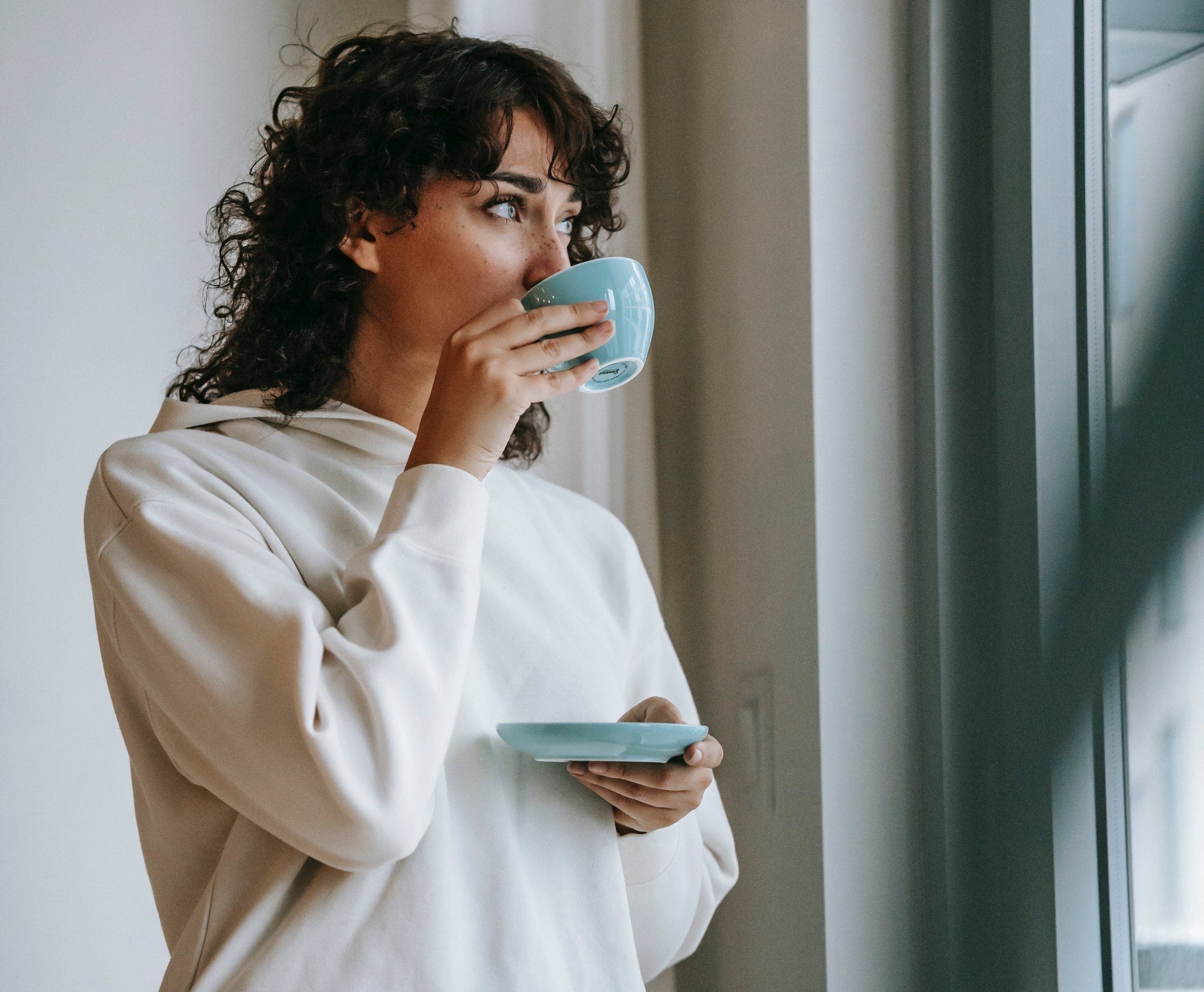 Woman peacefully sipping coffee
