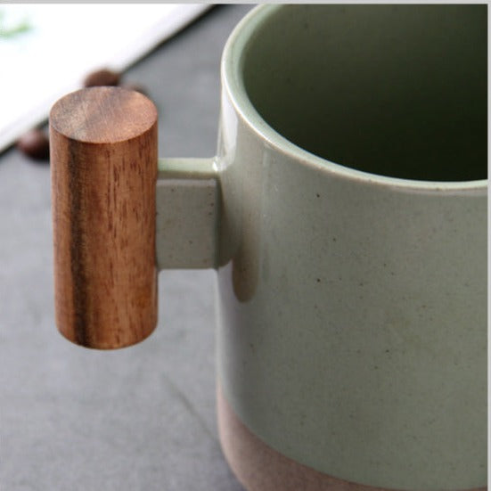 vintage cermaic mug with woodden handle jade close up