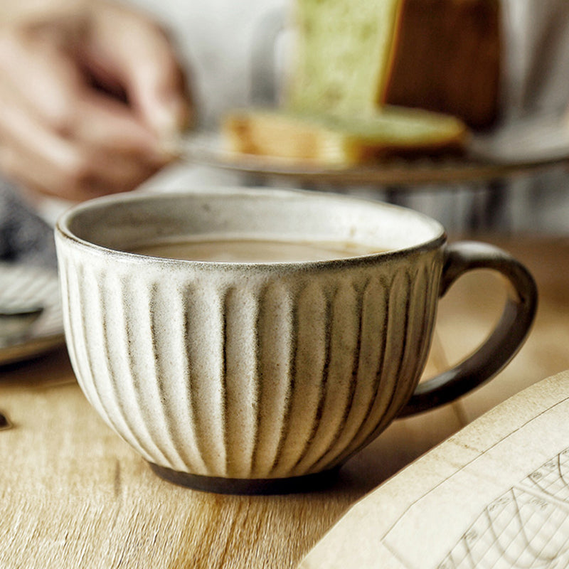 Rough pottery ceramic mug on table